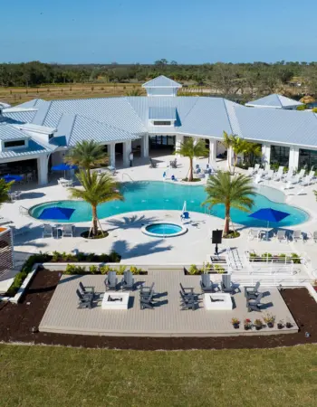 Luxury RV park in Florida with motorcoach sites surrounded by palm trees and a large swimming pool.