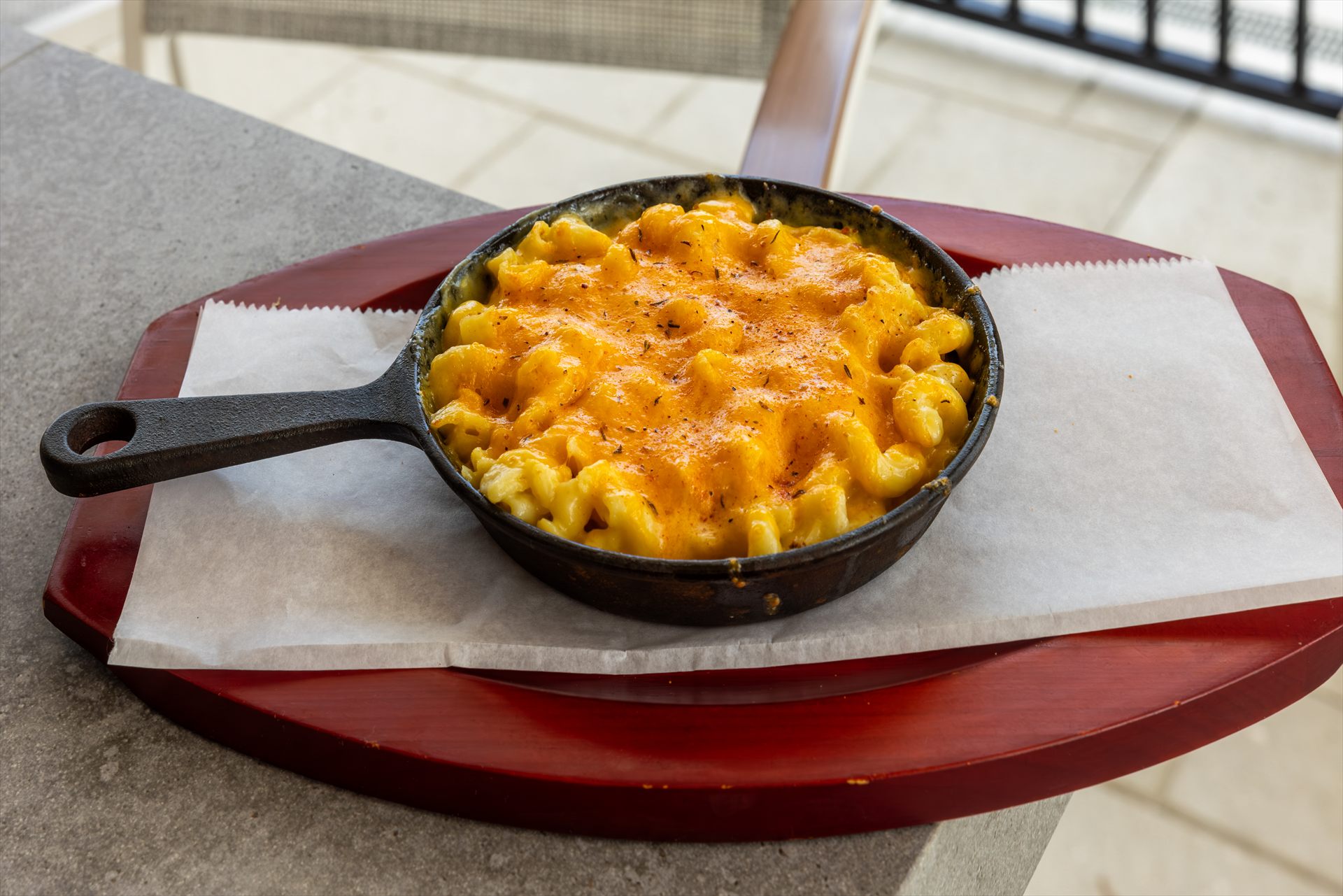 Baked mac and cheese served in a cast iron skillet at Flip Flops